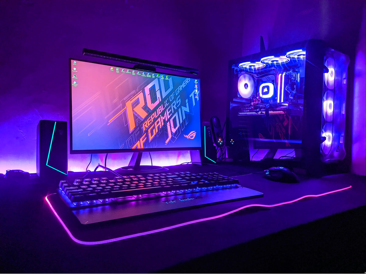 Gaming PC setup glowing in purple light